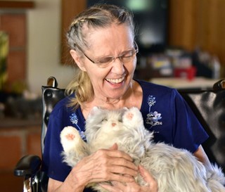 Dementia patient Donna (Dee) Winston plays with mechanical cat