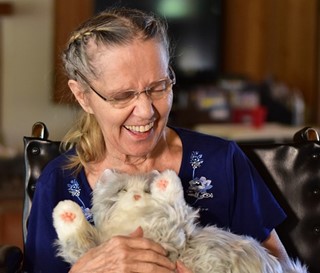 Dementia patient Donna (Dee) Winston plays with mechanical cat