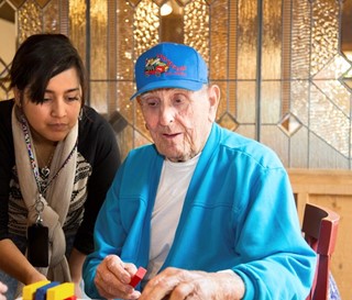 Volunteer Destiny Barriga with a patient at Gardiner Home