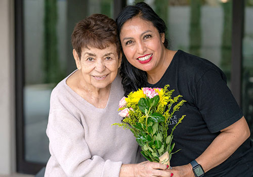 Volunteer helping woman with flowers