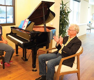 Steve Harnden enjoys a private concert by HOV volunteer Krishna Sinha.