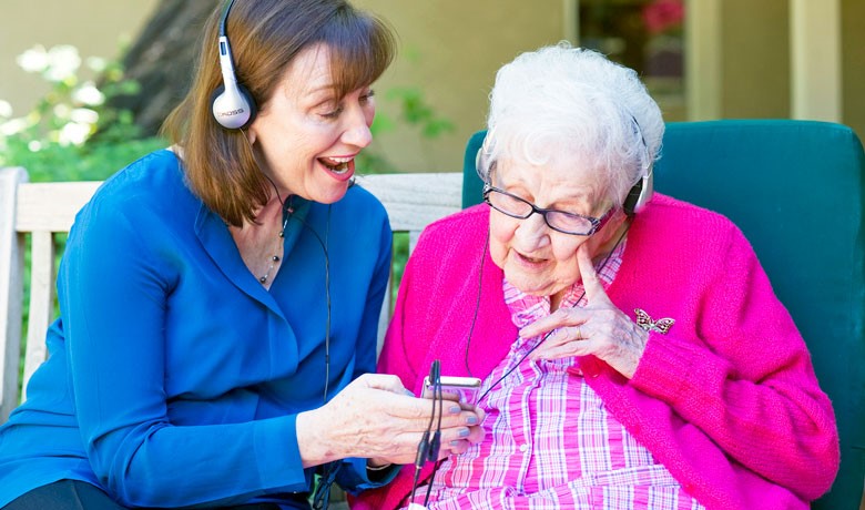 Maribeth Gallagher listening to music with dementia patient