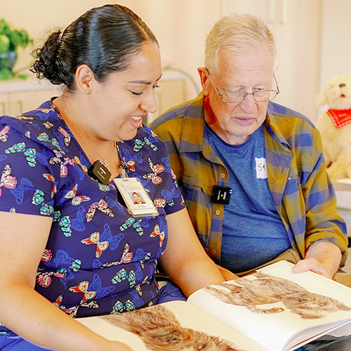Sonja Marti, SCD Respite Caregiver with male patient reading book