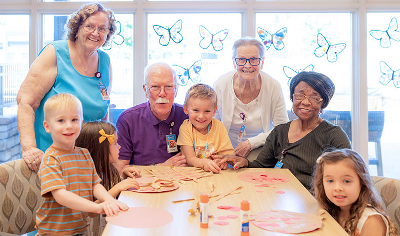 Adult Day put together puzzle with YMCA children