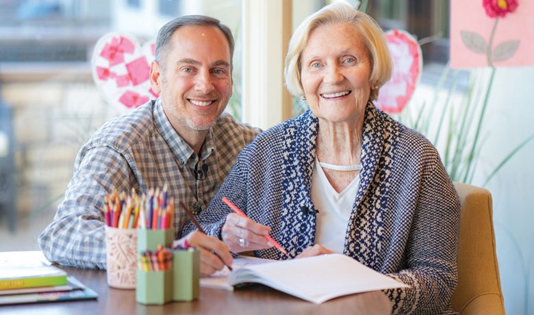 Assisted Living patient drawing with volunteer