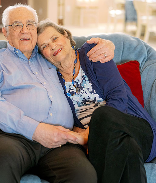 Couple hugging on sofa